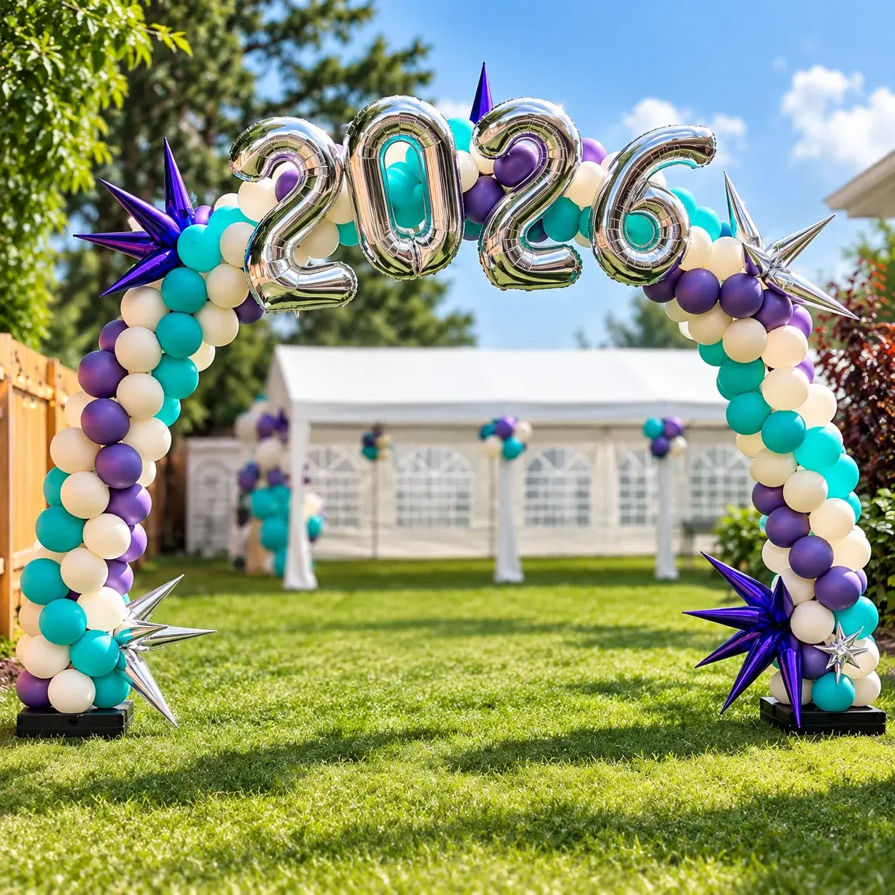 Walk-through balloon arch in teal, purple and cream with a silver 2026 in foil and chrome star bursts