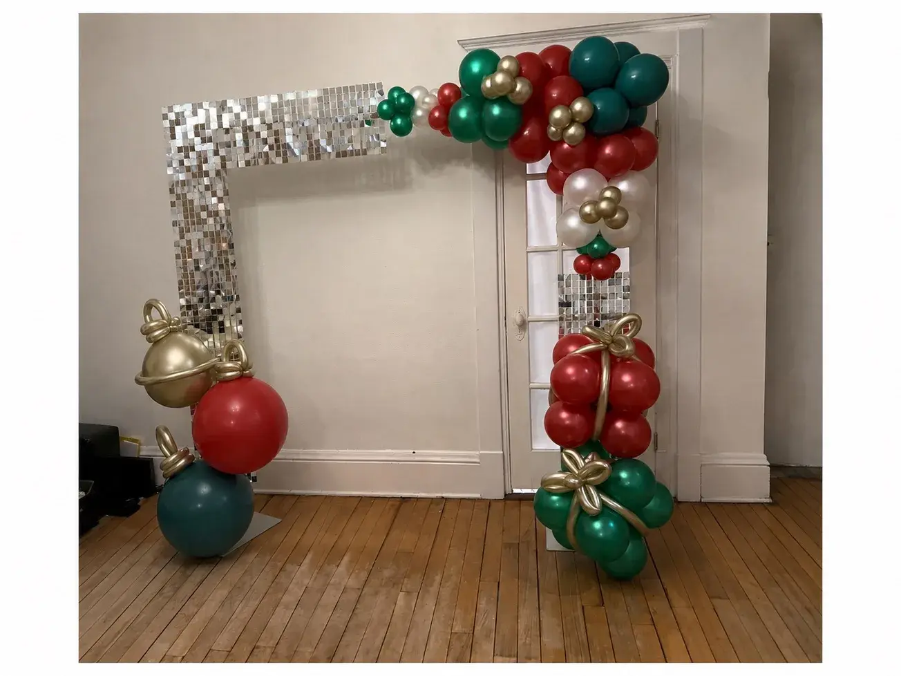 Silver shimmer wall doorway dressed with a red, green and gold Christmas garland